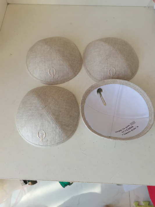 Beige kippahs with tonal monogram embroidery and interior printing; interior name hidden
