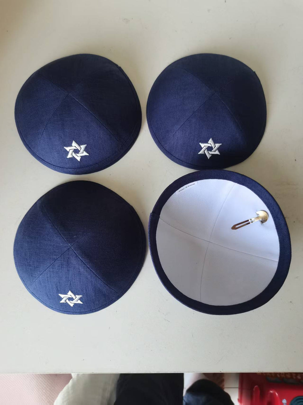 Navy kippahs with a white embroidered motif